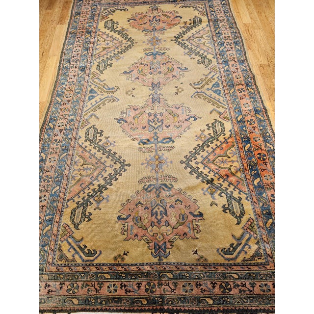 This early 20th century Turkish Oushak rug is a luminous example of Anatolian craftsmanship at its most architecturally...