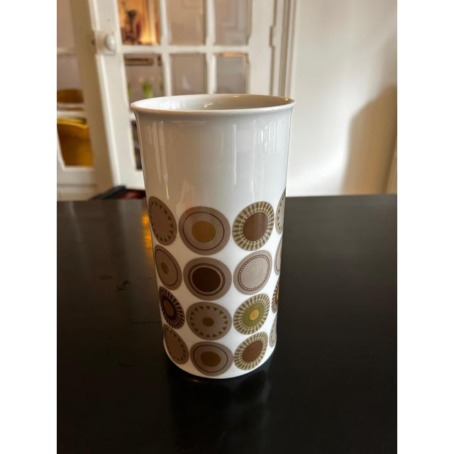 White porcelain vase from the 1970s decorated with yellow, gold, bronze, and gray dots. Design by Hans Theo Baumann,...