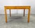 Mid-century modern coffee table produced in Denmark during the 1960s. The table features a square teak tabletop with a...