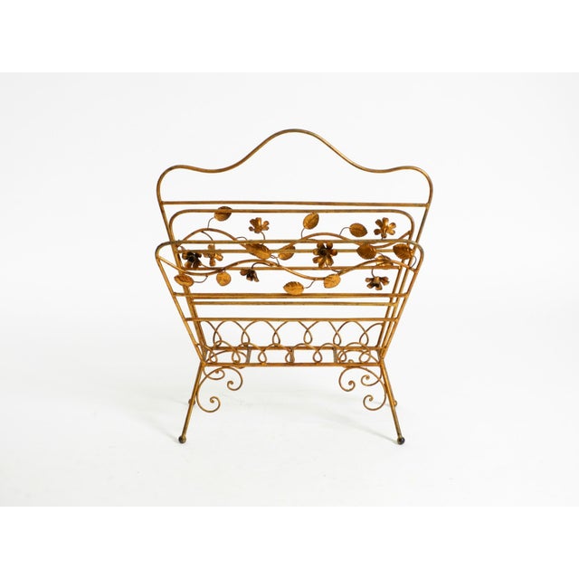Stunning Mid-Century Modern original newspaper or magazine rack. The Metal frame is gilded. Stunning floral design with...