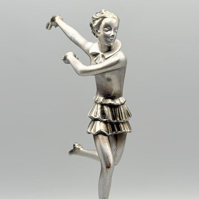 An art deco cold painted bronze sculpture by josef lorenzl (1892-1950). A running girl with a patinated dress and...