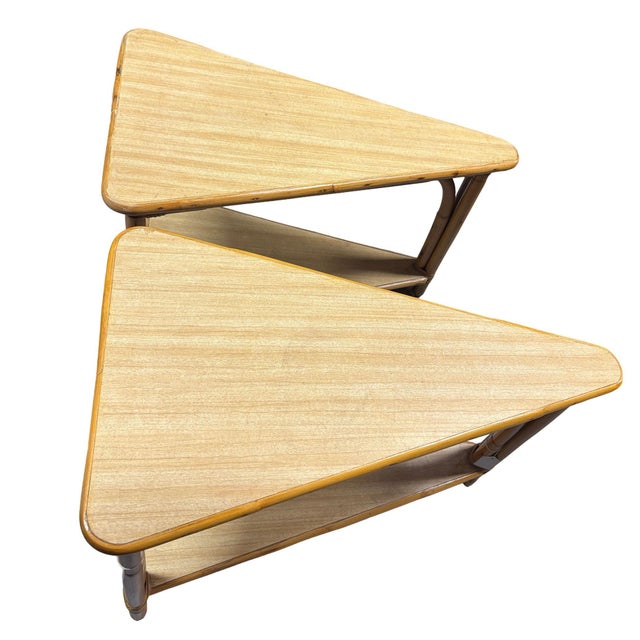 This beautifully restored pair of rattan and blonde Formica side or end tables in the shape of a wedge with 2-tiered...