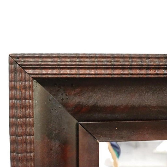 This large antique mirror features a classical design, crafted from flame mahogany with a distinctive ripple edge. The...