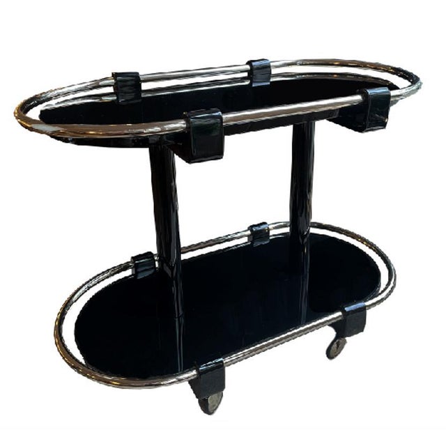 Oval Art Deco bar cart France around 1930. All-round, chrome-plated and curved railing. 4 brackets support the glass...