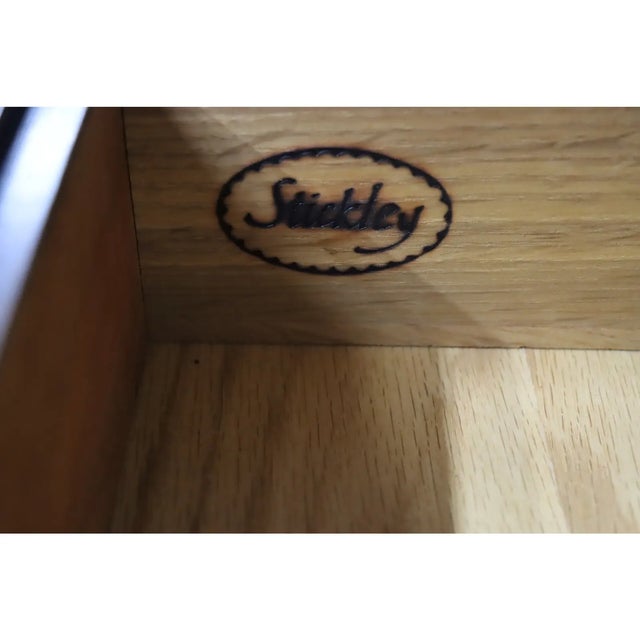 Abundant storage with 3 large and two small drawers on the exterior and a variety of small sized drawers behind the drop...