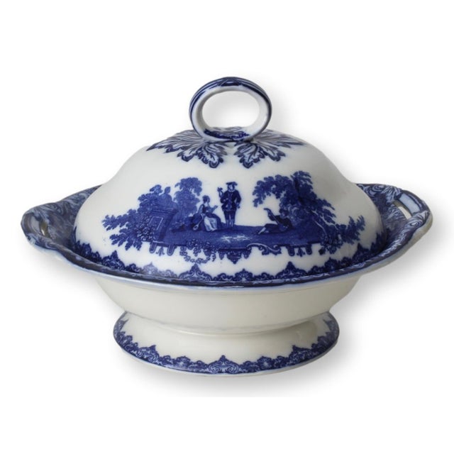 Antique Doulton flow blue comport with lid in the 'Watteau' pattern, circa 1920s. This exquisite piece features romantic...