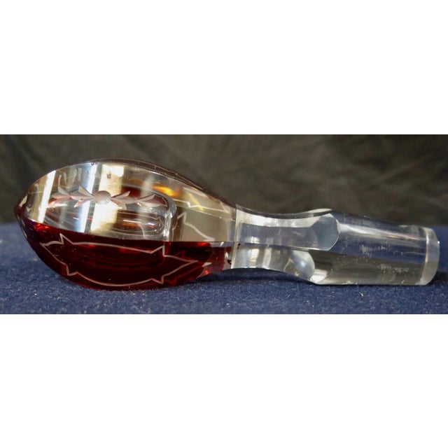 This vintage early 20th century Bohemian crystal decanter is designed with eight acid etched panels. The cranberry panels...