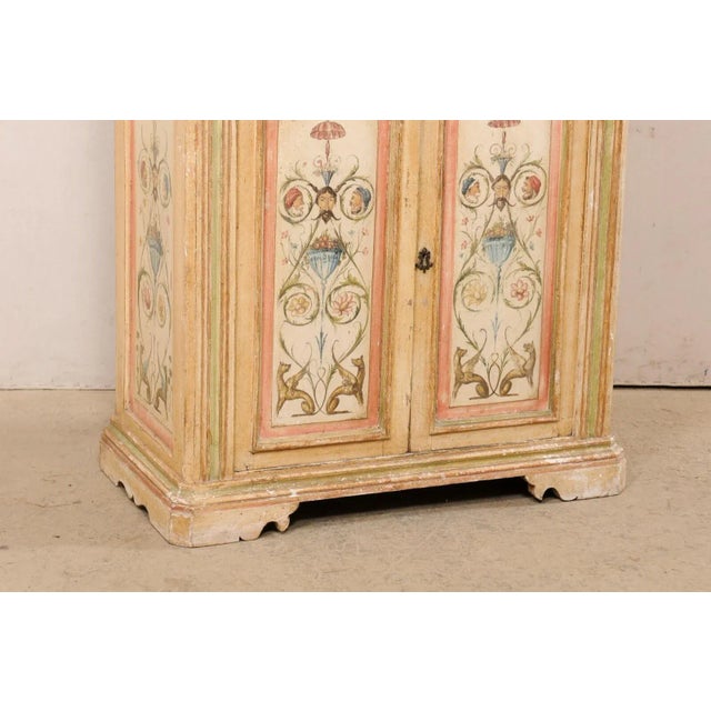 An Italian hand-painted cabinet from the 18th century. This antique cabinet from Italy has a rectangular-shaped top which...