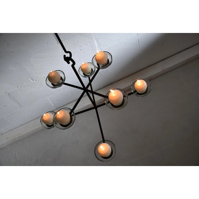 Mid-Century Modern Scandinavian chandelier. The chandelier holds eight glass candleholders. Measurements: D.60 x H.133...