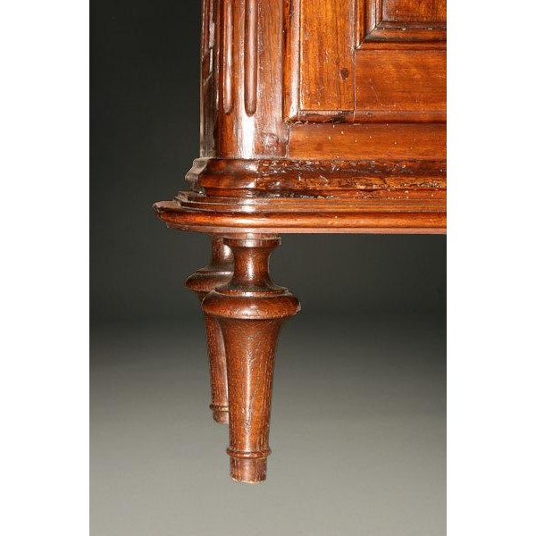 A charming 19th-century French walnut vitrine from Provence, showcasing the timeless character of traditional French...