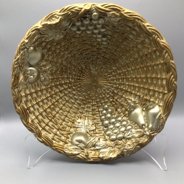 Very unusual gold ceramic/plaster fruit bowl in a woven wicker pattern. The bottom has raised letters “Italy” with raised...