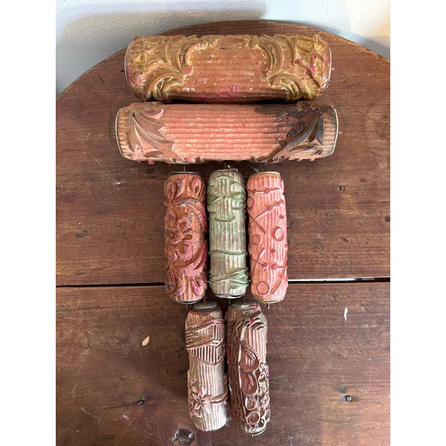 A striking collection of antique European wallpaper printing rollers, dating to the late 19th to early 20th century,...