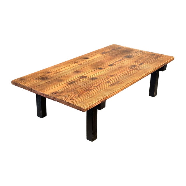 A provincially simple and elegant, low Japanese wood tea table. A raw wood table top with ebonized legs and cross-...