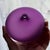 Charming signed studio art glass bud vase by Nick Kekic, featuring a compact sculptural form in a rich purple tone. The...