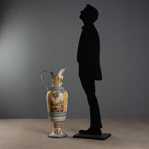 Large polychrome majolica amphora with an oval body on a high foot. Ribbon handle and everted spout. Decorated with...