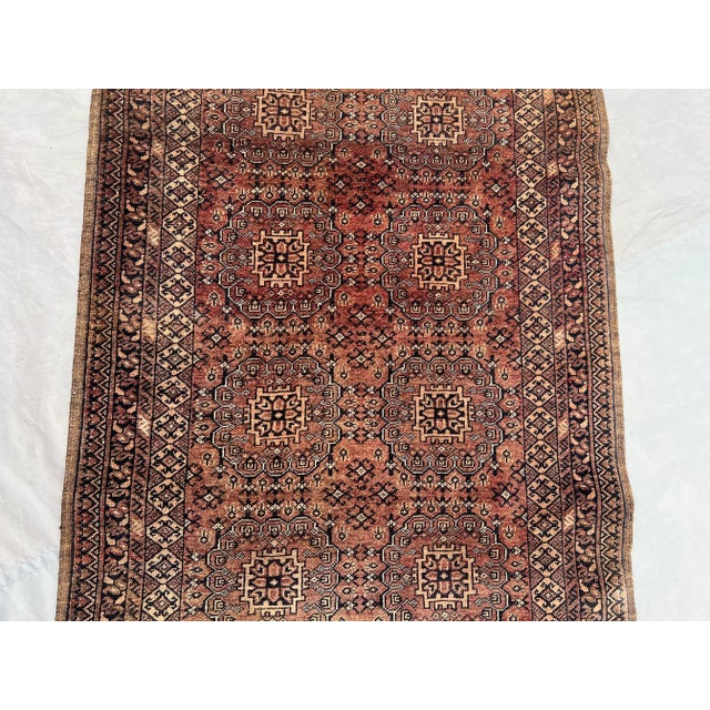 This beautiful vintage Afghan Turkmen Ersari runner rug features the timeless Bokhara design, characterized by repeating...
