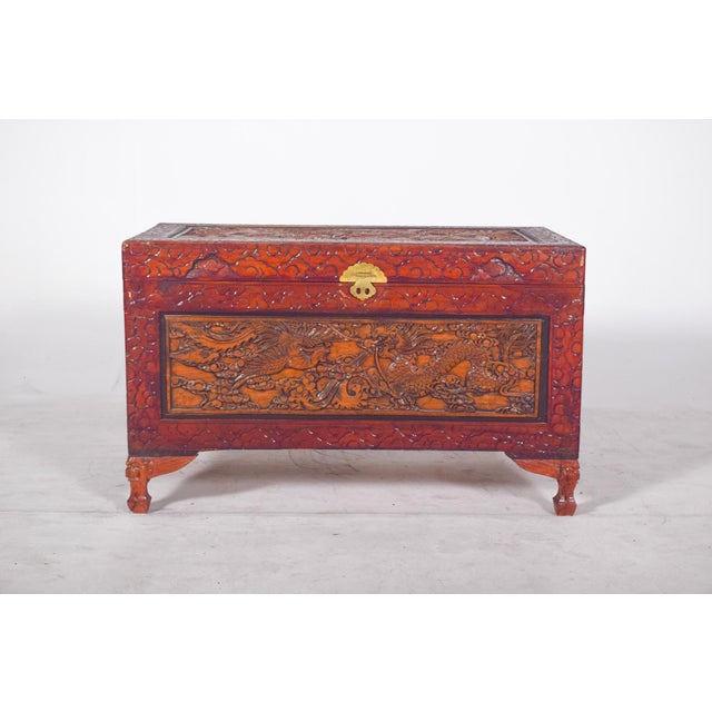Oriental carved chest. The front features a scene of dragons among clouds, a symbol of power and protection in Chinese...