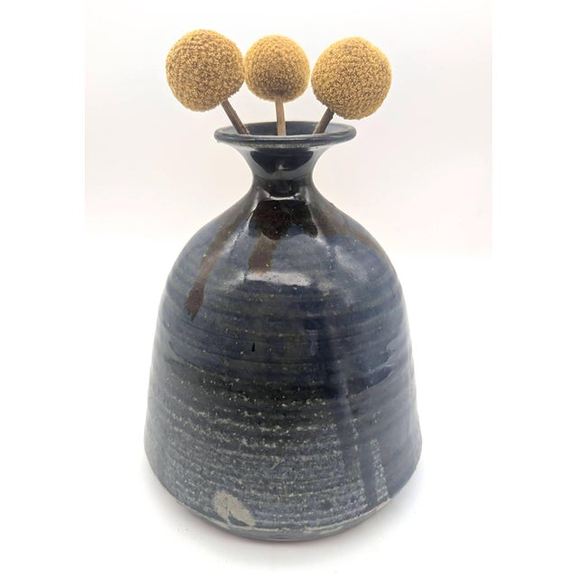Offered is a circa. 1970s glazed stoneware wheel-turned vase with a drip glaze. It bears an illegible signature on the...