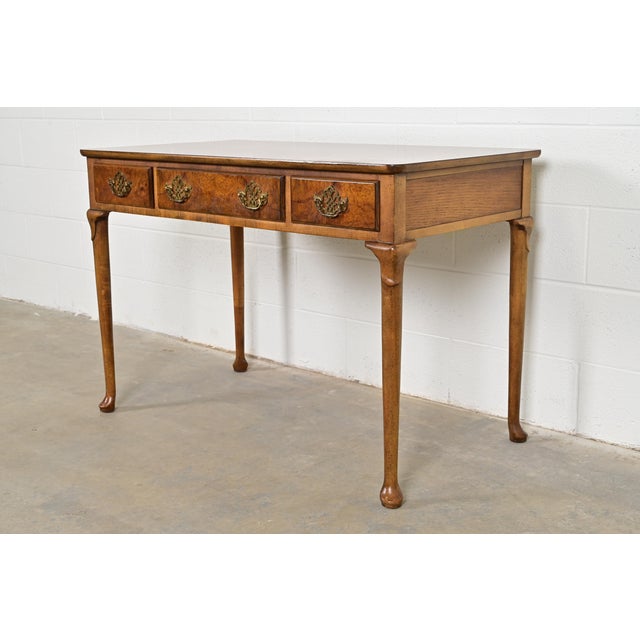 A gorgeous Queen Anne or Georgian style writing desk By Baker Furniture USA, Circa 1960s Beautiful book-matched burled...