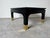Elegant and sculptural coffee table by Harrison Van Horn, featuring a rich black grasscloth–textured finish that adds...