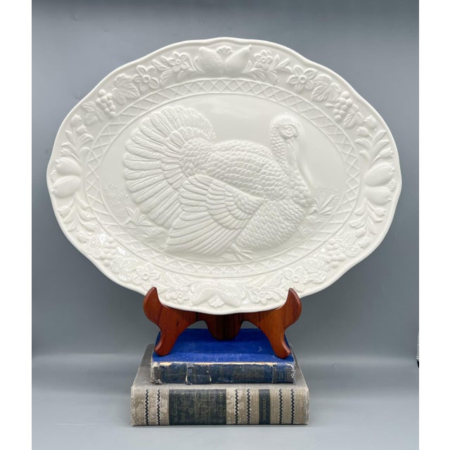 Large mid-late 20th century ceramic serving platter featuring a beautifully embossed turkey at the center, framed by a...