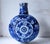 Elegant blue floral ceramic moon flask vase with traditional hand-painted design. The vivid blue and white pattern adds...