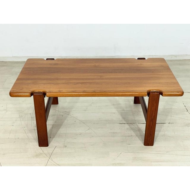 Stylish mid-century coffee table by Danish designer Niels Bach. This piece of furniture is distinguished by its high-...