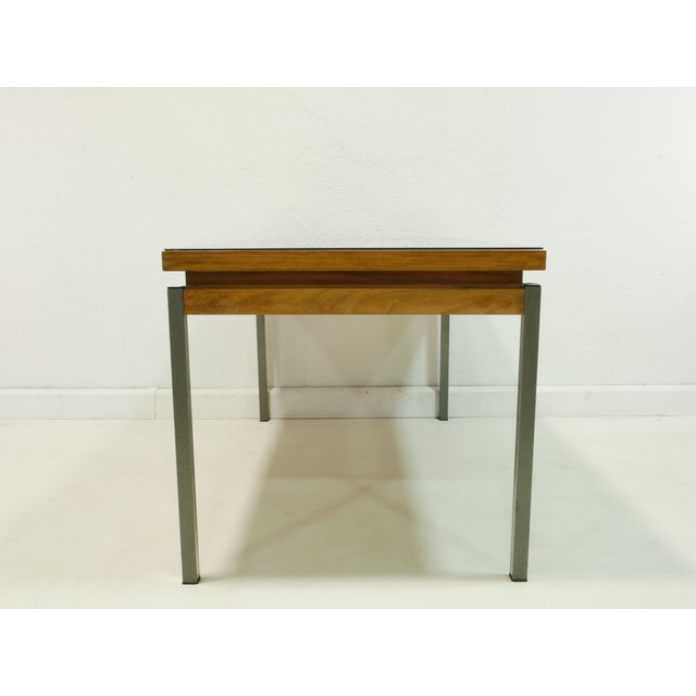 Elegant vintage coffee table from the 1960s with a high-quality walnut surface and a floating glass top. The clean lines,...