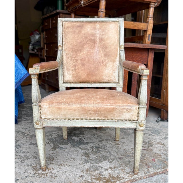 Stunning smaller scale antique armchair, has intact older kid leather and small nailhead upholstery.
