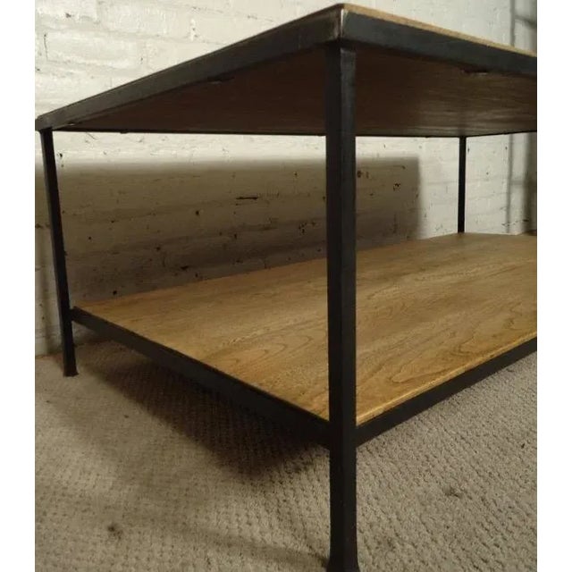 Contemporary coffee table featuring solid iron frame and two levels with beautiful walnut grain throughout. Please confirm...