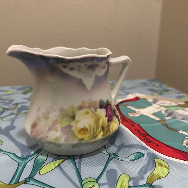 Add a touch of Victorian elegance to your tea service with this beautiful vintage porcelain creamer. This piece features a...
