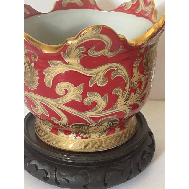 Impressive pair if Antique Chinese porcelain red gold floral cadhepots. Placed on round wood carved stands.