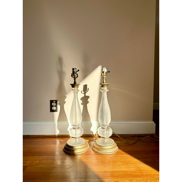 A stunning pair of antiqued glass table lamps with aged brass and effortless, old-world charm. Each lamp features an...