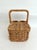 This seemingly unused vintage rattan/wicker basket features a lidded and hinged compartment for food and two cylindrical...