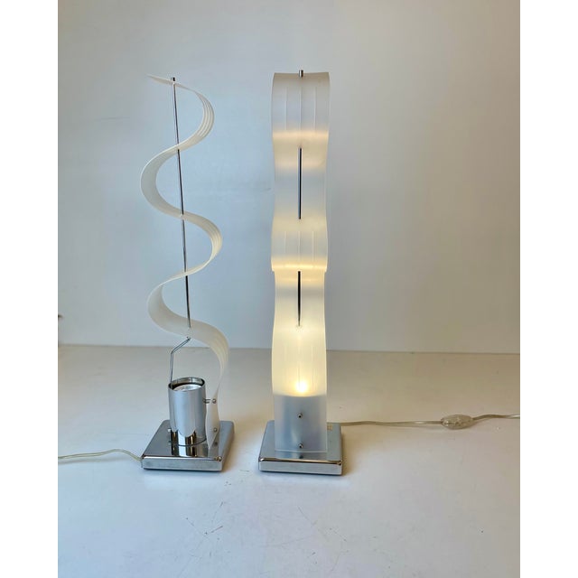 Set of two sculptural table lamps with a sheet of acrylic compressed and stretched onto a chrome-plated metal base. Design...