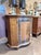A charming vintage Italian console cabinet distinguished by its beautifully hand-painted floral decoration and graceful...