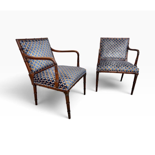 A stylish pair of Vintage Hollywood Regency faux bamboo armchairs, circa 1970s, featuring elegant sculpted frames and a...