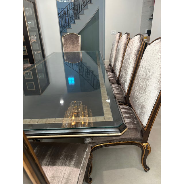 Marge Carson dining table from the Rue Royale collection, having a textured gilt inlay on an exotic hardwood top, over a...