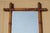 A charming antique English decorative wall mirror, featuring a beautifully turned faux bamboo wooden frame and lightly...