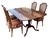 Classic dining set featuring a solid wood expandable table and four elegant cane-back chairs. Warm tones with graceful...