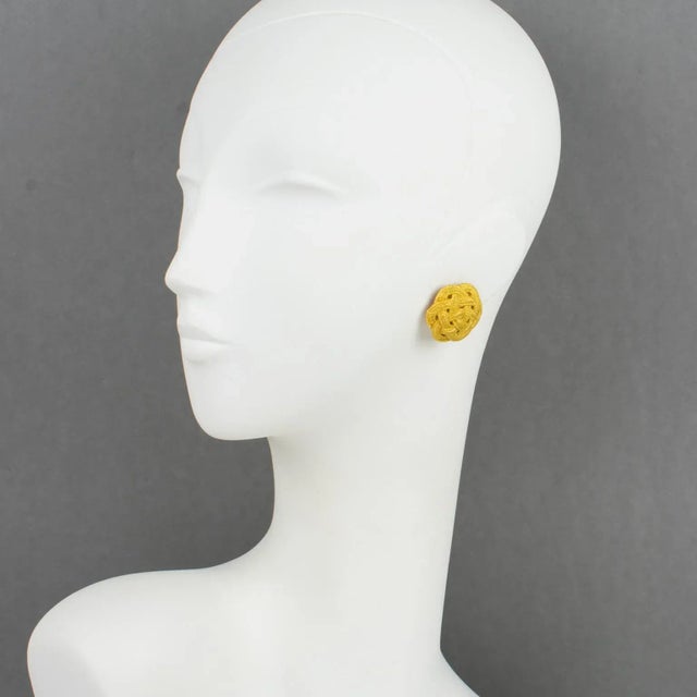 These elegant Emanuel Ungaro Paris couture clip-on earrings feature a gilt metal domed rounded shape with a braided carved...