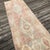 A Vintage Turkish Runner Rug with Anatolian Heritage Step into history with this exquisite hand-knotted runner from...
