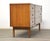 A mid century modern cherry dresser made by Dixie Furniture with inset pulls and nine dovetail drawers. 64” wide. 18.5”...