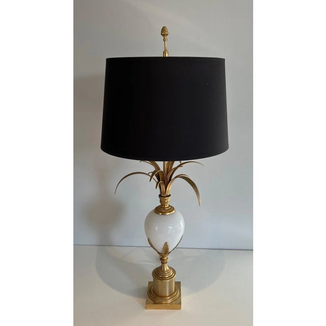 Table lamp in gilt nickel and white opaline ostrich egg. French work in the style of Maison Charles. Circa 1970 Our...