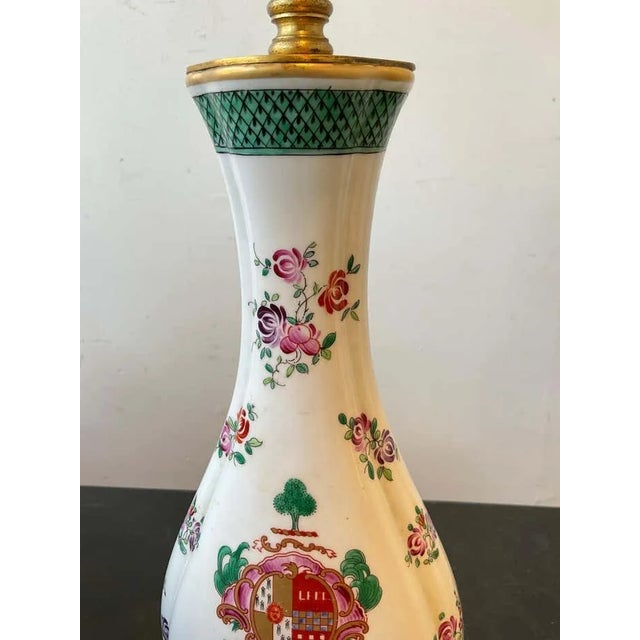 Pair of 1940s Armorial Samson French porcelain vases that were turned into lamps. On gilt bronze bases. Needs rewiring....