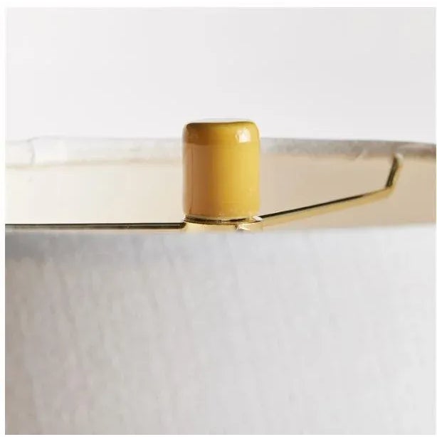 With a perfectly rounded ceramic body and a rich marigold high gloss glaze, this lamp adds a pop of color to any setting....