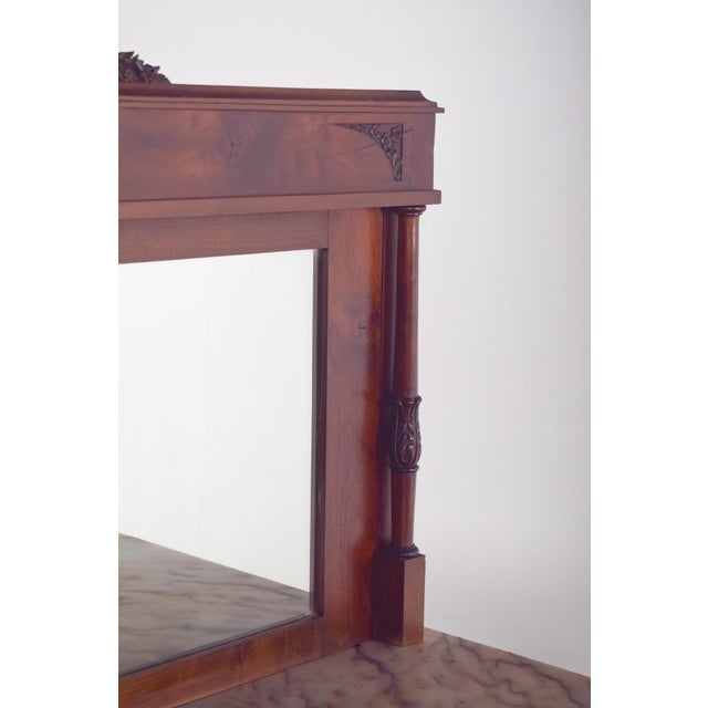 Sideboard with mirror and marble top. The upper structure houses a rectangular mirror flanked by small turned columns,...