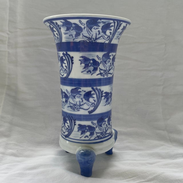 This vintage Chinoiserie white and blue footed Koi vase is a handmade piece originating from China. With a Chinese culture...