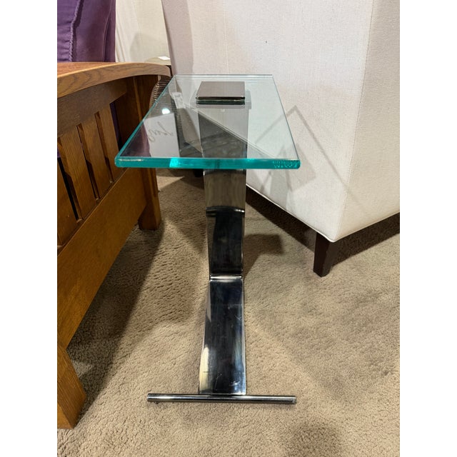 Add a sleek note of vintage modernism with this DIA brushed nickel and glass-top side table, a sculptural accent piece...
