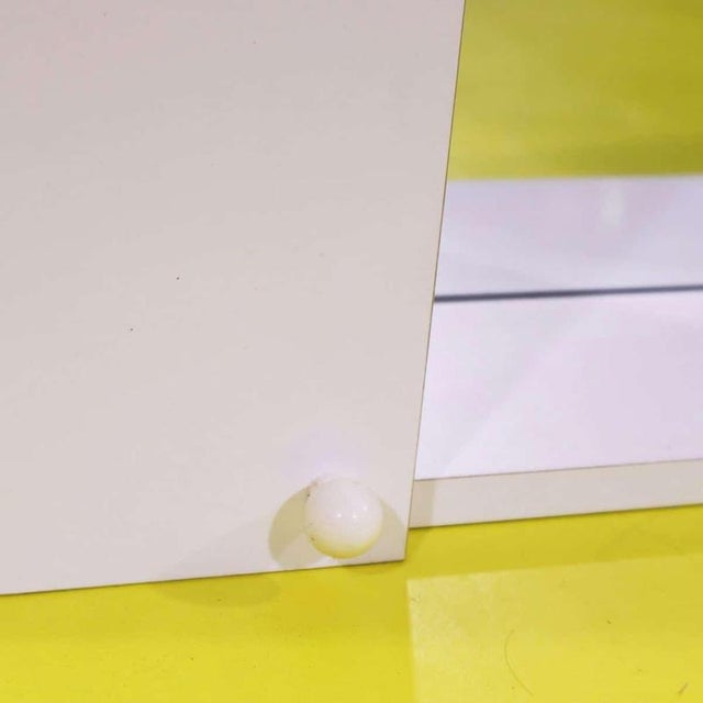 Wall-mounted cabinet in white particle board featuring a mirror.